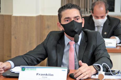 #PraCegoVer: Vereador Franklin fala ao microfone assentado à sua tribuna durante a sessão da Câmara. Ele usa uma máscara.